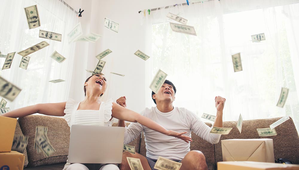happy couple smiling successful sitting money rain business online concept
