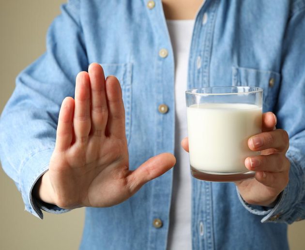 Woman hold glass of milk, front view