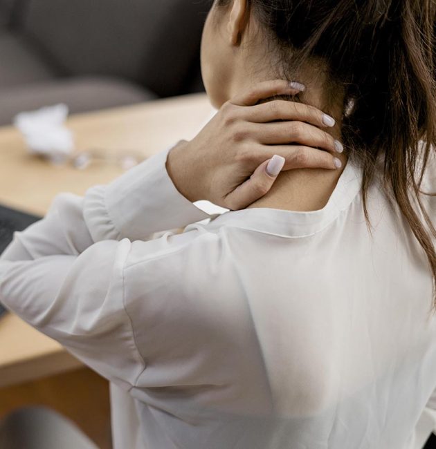young woman having neckache while working home
